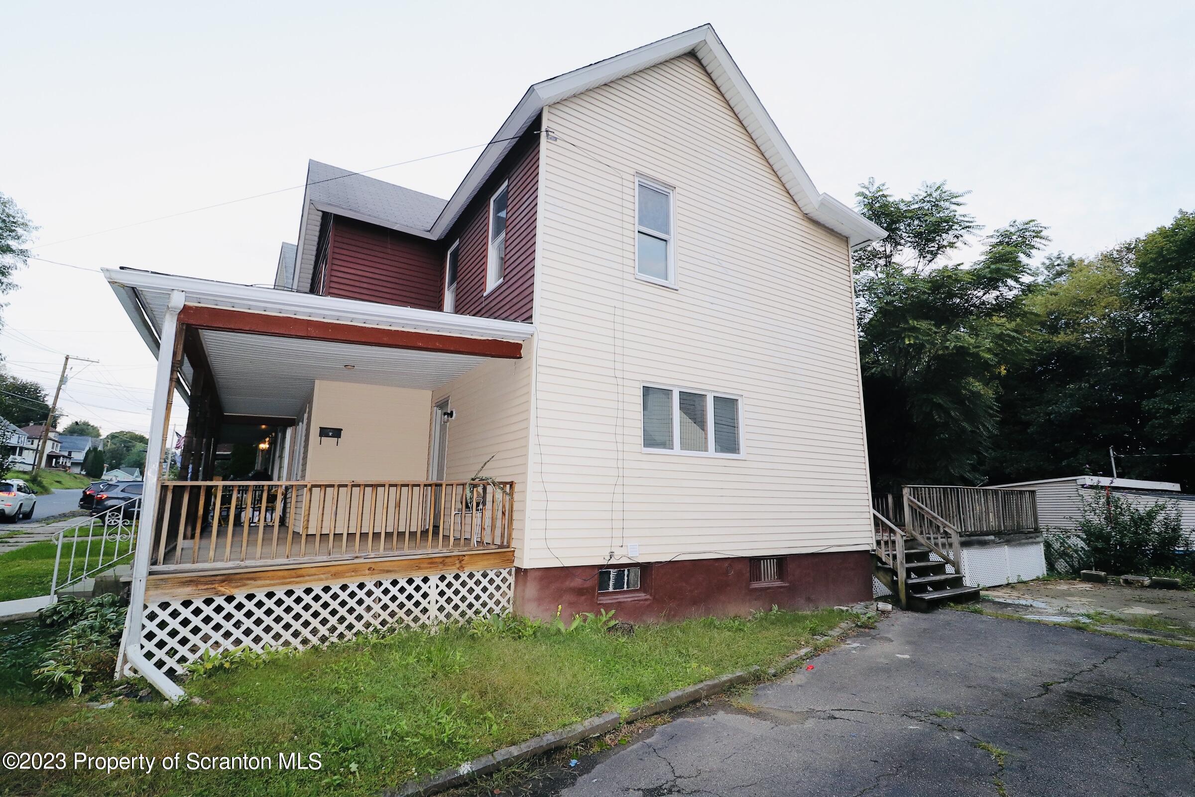 2308 Pond Avenue Scranton, PA 18508 - Photo 4 of 26 a front view of a house with a garden