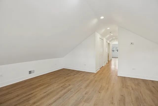 a view of hallway with wooden floor