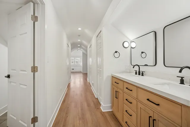 a spacious bathroom with a double vanity sink and a mirror
