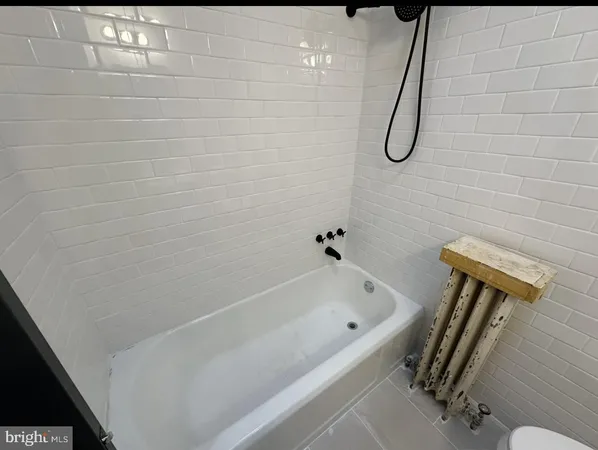 a bathroom with a bath tub and a shower