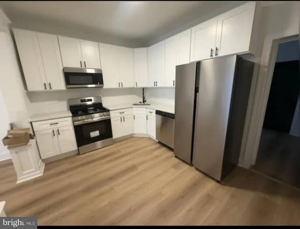 a kitchen with stainless steel appliances granite countertop a refrigerator stove and sink