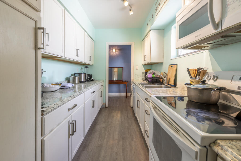 3729 Paula Avenue Key West, FL 33040 - Photo 14 of 28 a large white kitchen with stainless steel appliances granite countertop lots of counter top space