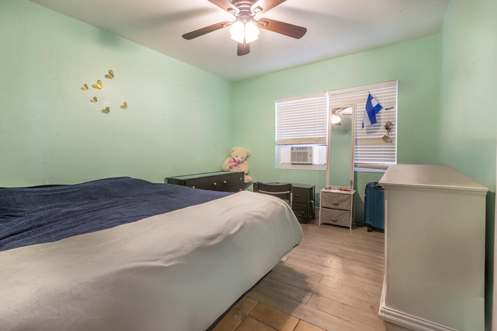 3729 Paula Avenue Key West, FL 33040 - Photo 22 of 28 a bedroom with a bed and a chandelier