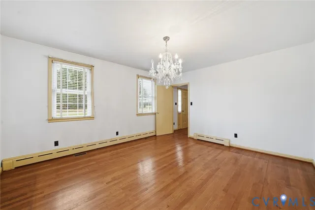 a view of wooden floor and windows in a room