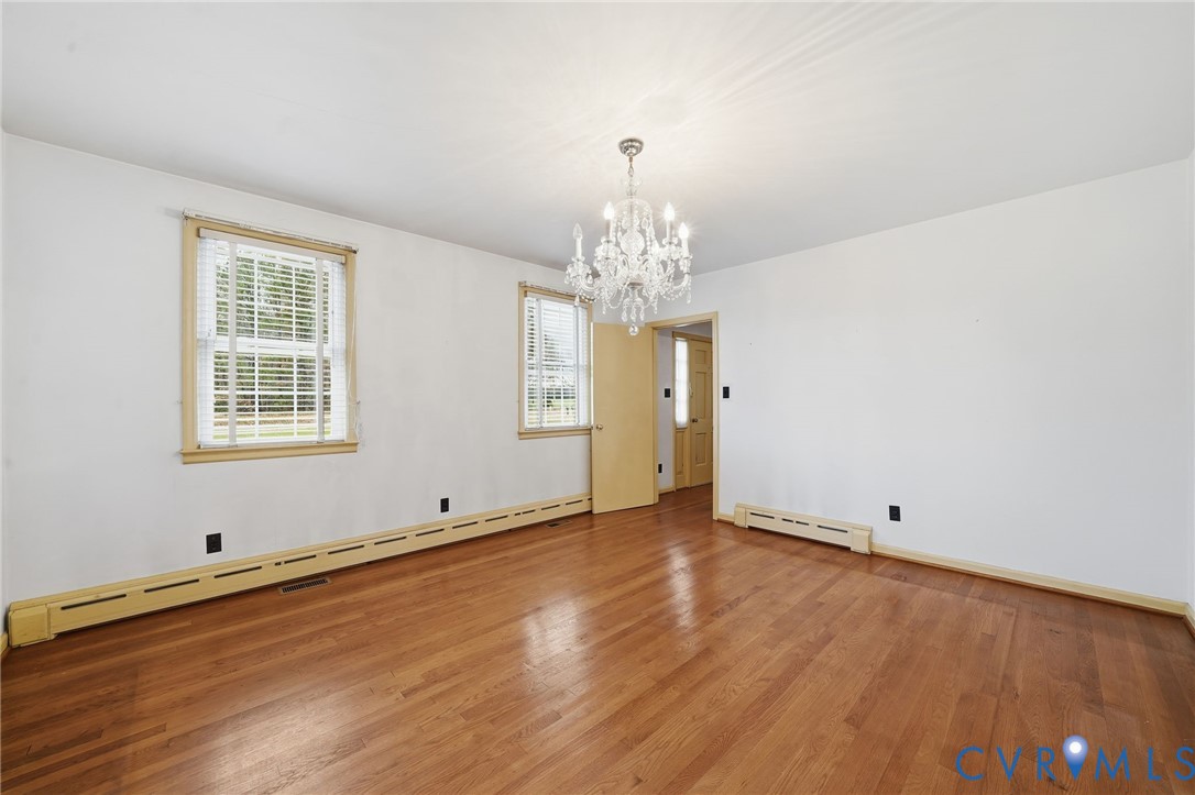 6726 Newtown Road St. Stephens Church, VA 23148 - Photo 16 of 50 a view of wooden floor and windows in a room