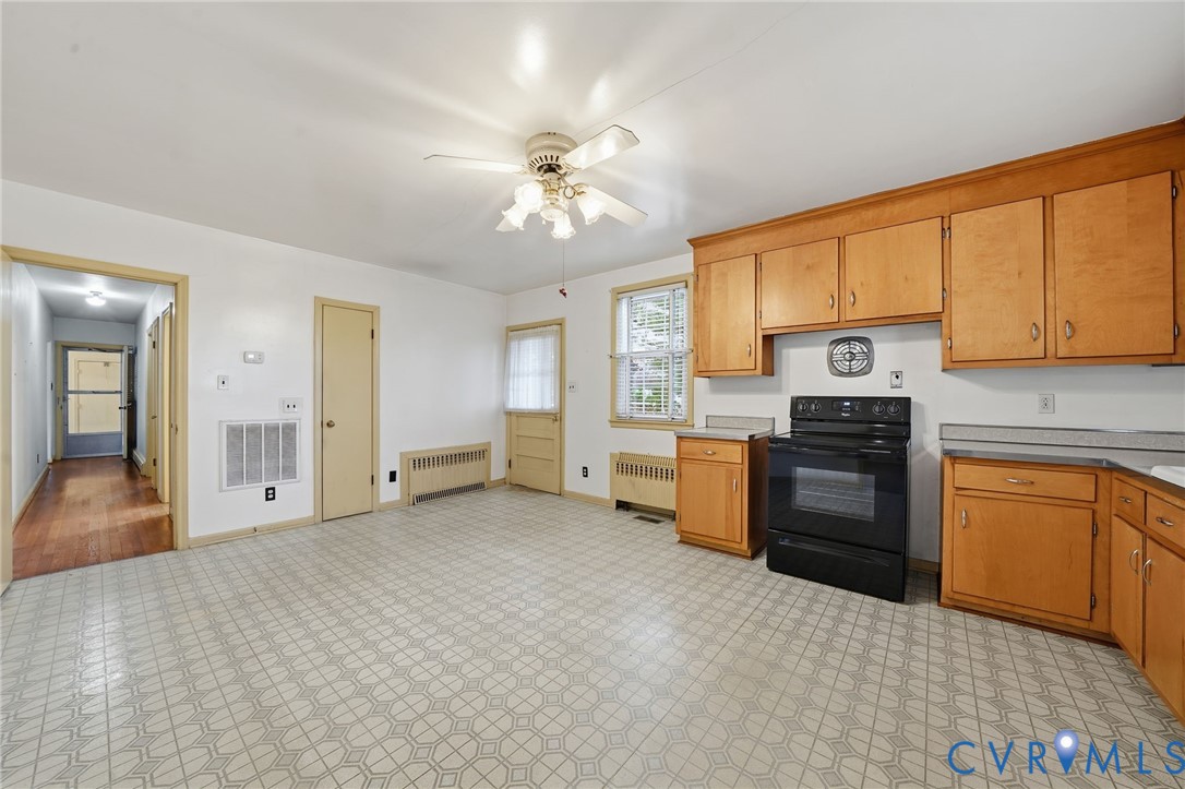 6726 Newtown Road St. Stephens Church, VA 23148 - Photo 24 of 50 a kitchen with granite countertop a stove top oven sink and cabinets