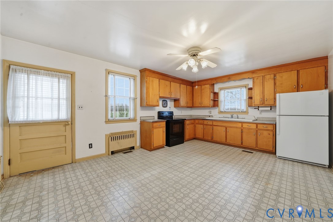 6726 Newtown Road St. Stephens Church, VA 23148 - Photo 25 of 50 a large kitchen with cabinets a sink a window and stainless steel appliances
