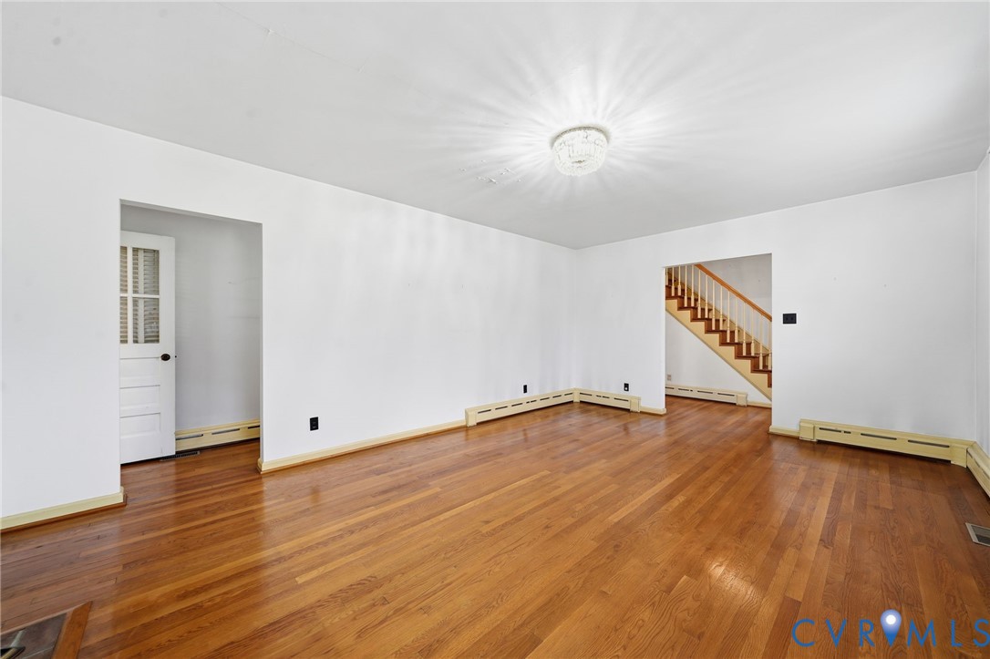 6726 Newtown Road St. Stephens Church, VA 23148 - Photo 29 of 50 an empty room with wooden floor and windows