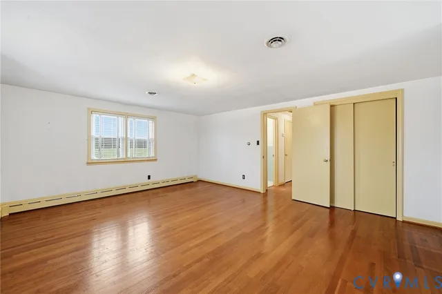 a view of a room with wooden floor and white walls