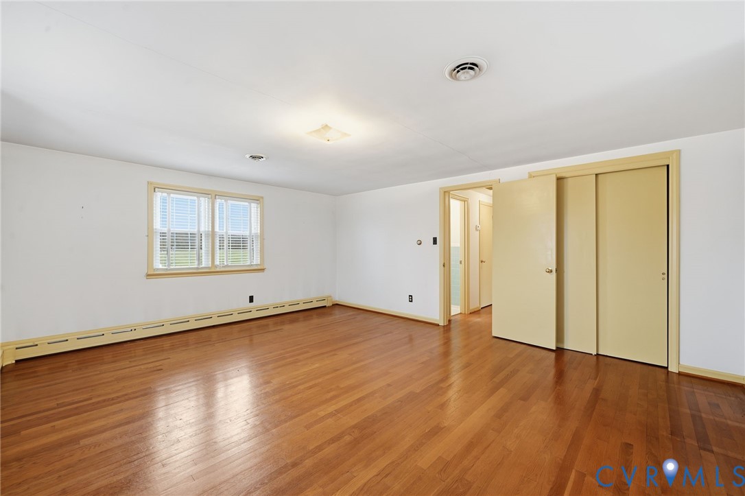 6726 Newtown Road St. Stephens Church, VA 23148 - Photo 38 of 50 an empty room with wooden floor and windows