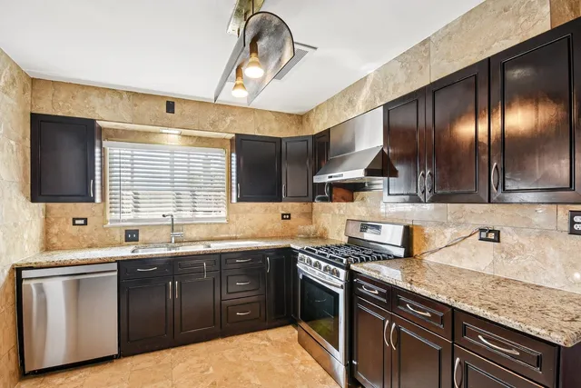 a kitchen with a sink stove and cabinets