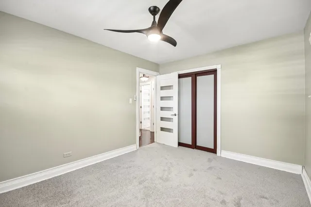 an empty room with a empty space and a ceiling fan