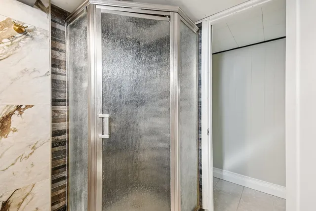 a view of a hallway with wooden floor and door