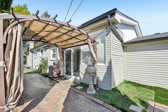 a view of a backyard with plants and patio