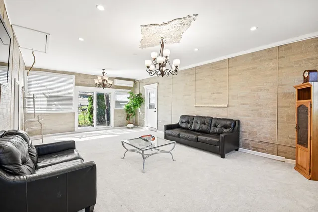 a living room with furniture and a chandelier