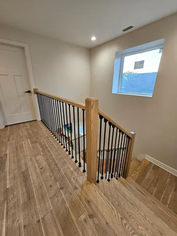 a view of a hallway with wooden floor