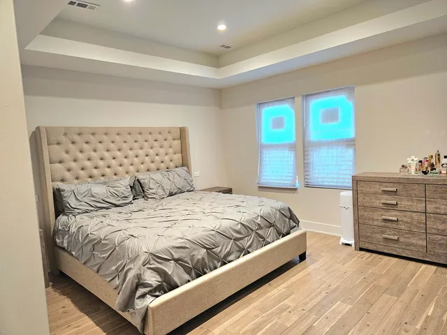 a bed sitting in a bedroom next to a window