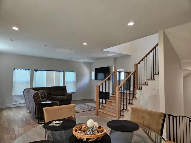 a living room with furniture and a wooden floor