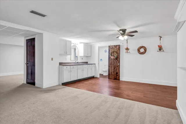 a view of kitchen with granite countertop cabinets and a sink