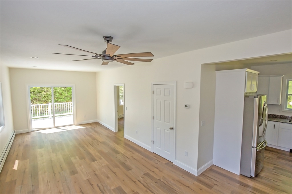 165 Sandisfield Road Sandisfield, MA 01255 - Photo 22 of 37 a view of a livingroom with wooden floor and a ceiling fan