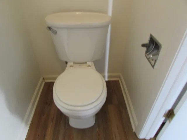 a white toilet sitting next to a white sink