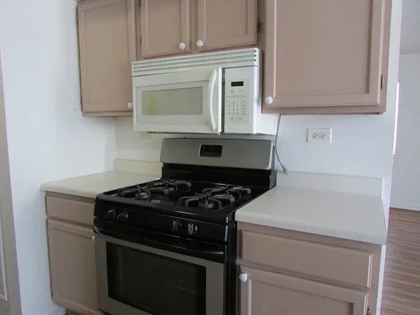 a stove top oven sitting inside of a kitchen