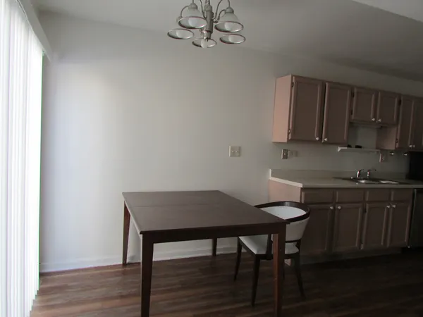 a view of a kitchen area with furniture and wooden floor