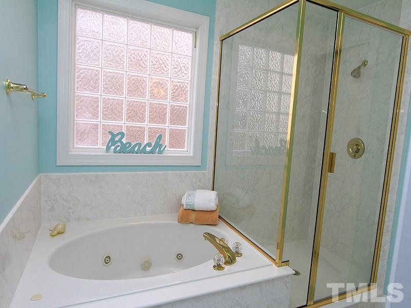 8209 Eden Close Court Raleigh, NC 27613 - Photo 11 of 20 Garden tub, shower and a water closet.