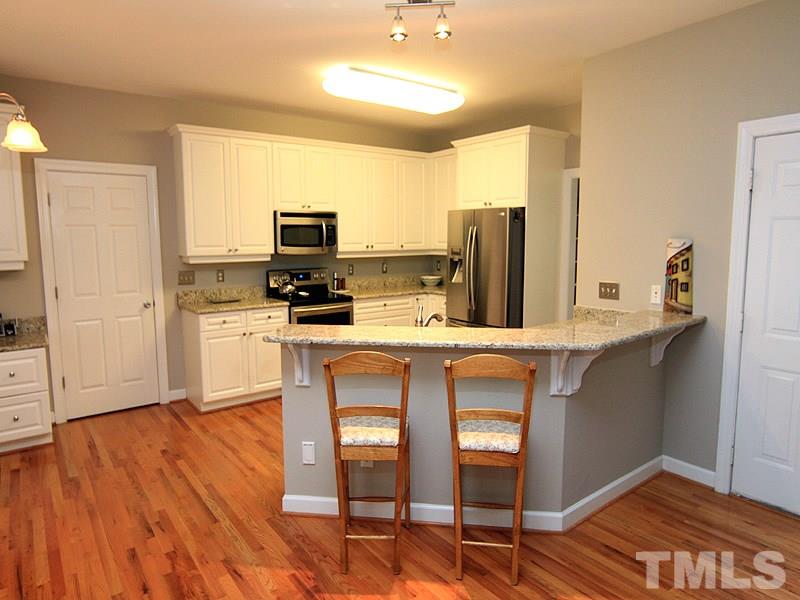 8209 Eden Close Court Raleigh, NC 27613 - Photo 5 of 20 Perfect for entertaining. Opens to family room. Door on left opens to mudroom.