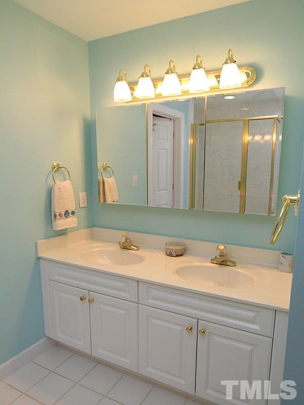 8209 Eden Close Court Raleigh, NC 27613 - Photo 10 of 20 Dual sinks and a large walk-in closet off the bathroom complete the master suite
