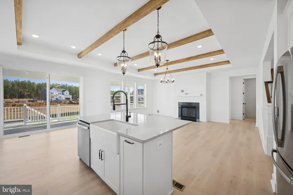 a kitchen with a sink a refrigerator and a stove top oven