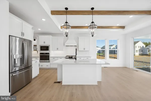 a kitchen with stainless steel appliances a stove a sink and a refrigerator