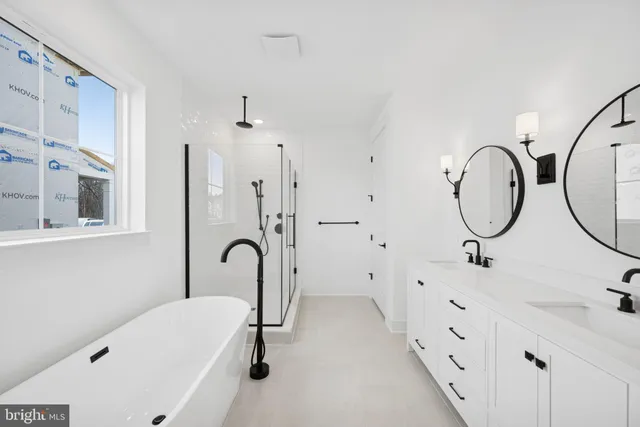 a bathroom with a tub sink and mirror
