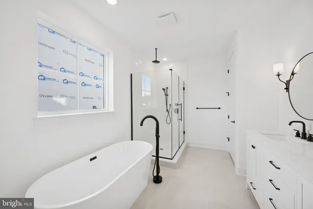 a bathroom with a tub sink and mirror