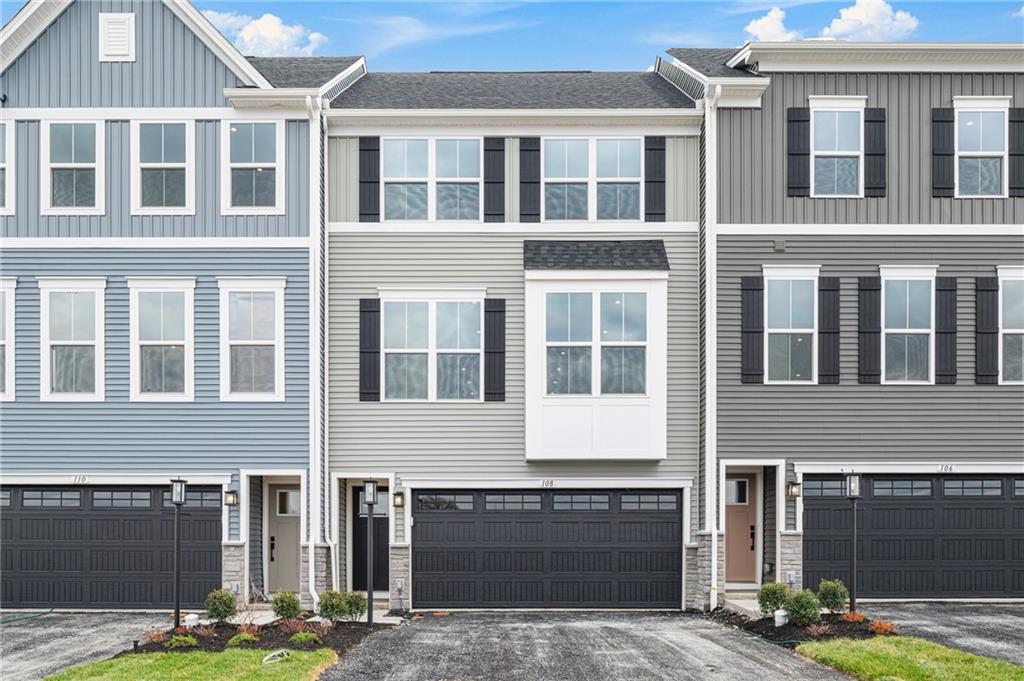 108 Scenic Ridge Drive Venetia, PA 15367 - Photo 1 of 32 a front view of a building with glass windows and a street