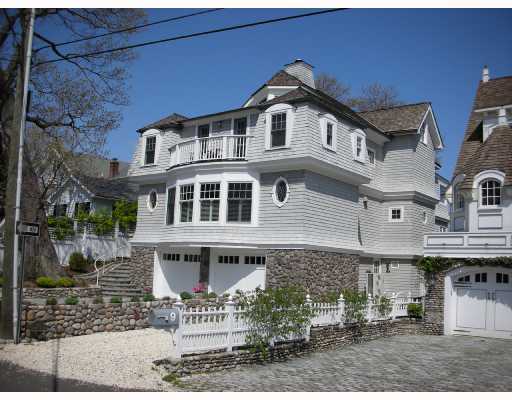a front view of a building with streets and trees