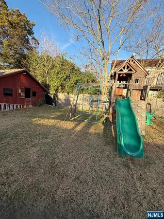 a view of a house with backyard and a car