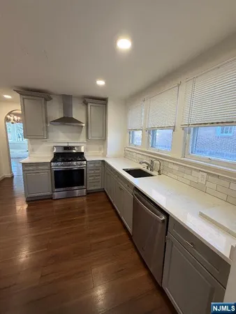 a white toilet sitting next to a white sink and vanity