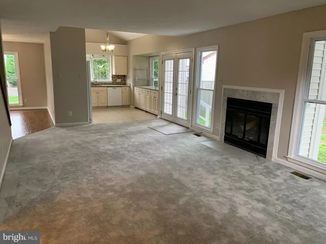 a view of empty room with a fireplace