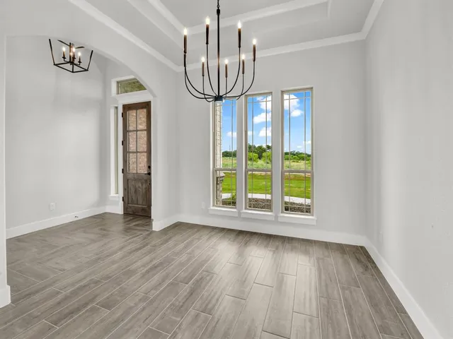 a view of a room with wooden floor fan and window