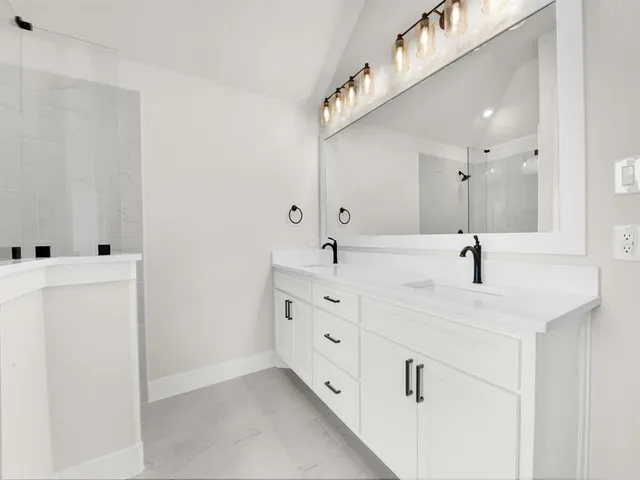 a bathroom with double sink and three mirror