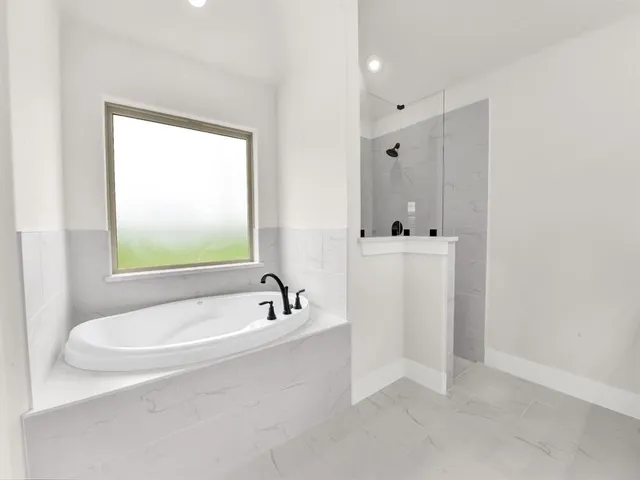 a bathroom with a bathtub and a sink