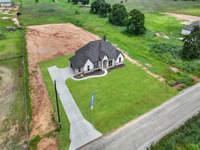 a view of a backyard with table and chairs with plants