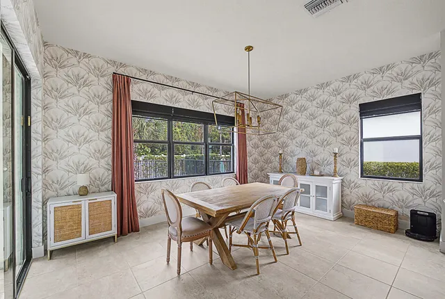 a bathroom with a granite countertop double vanity sink a mirror and a bathtub