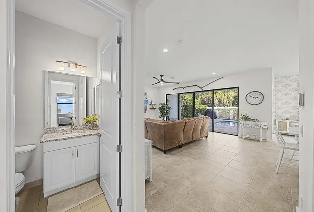 a view of a backyard with plants and a wooden bench