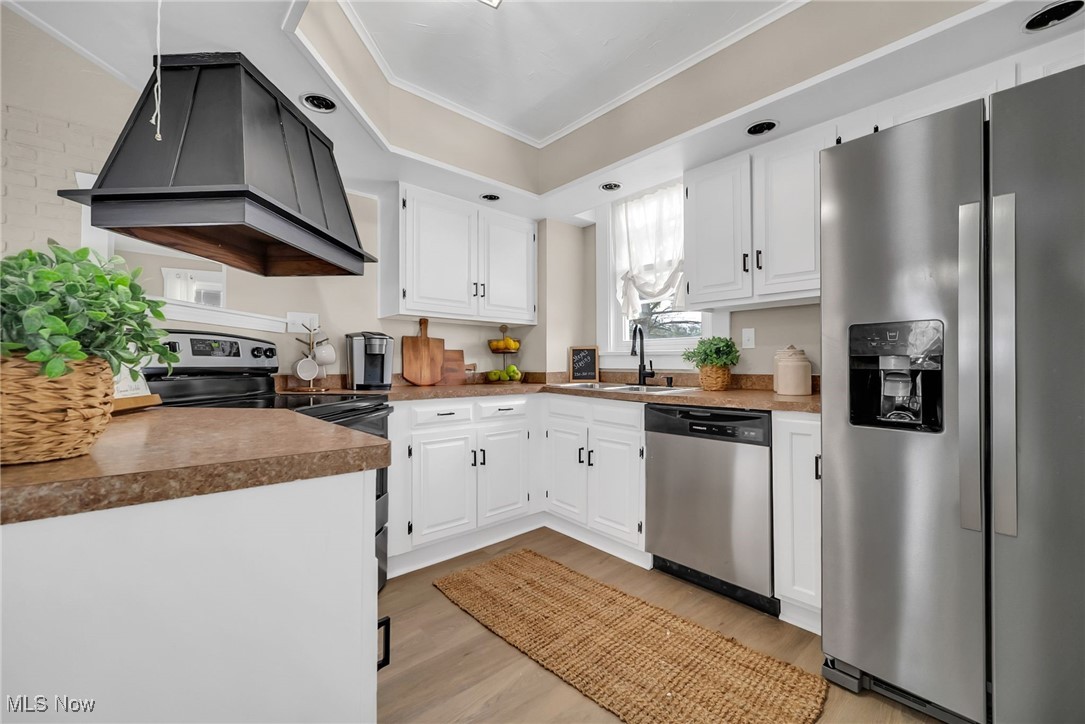404 Niles Vienna Road Vienna, OH 44473 - Photo 6 of 48 Kitchen featuring custom exhaust hood, appliances with stainless steel finishes, ornamental molding, white cabinets, and a sink