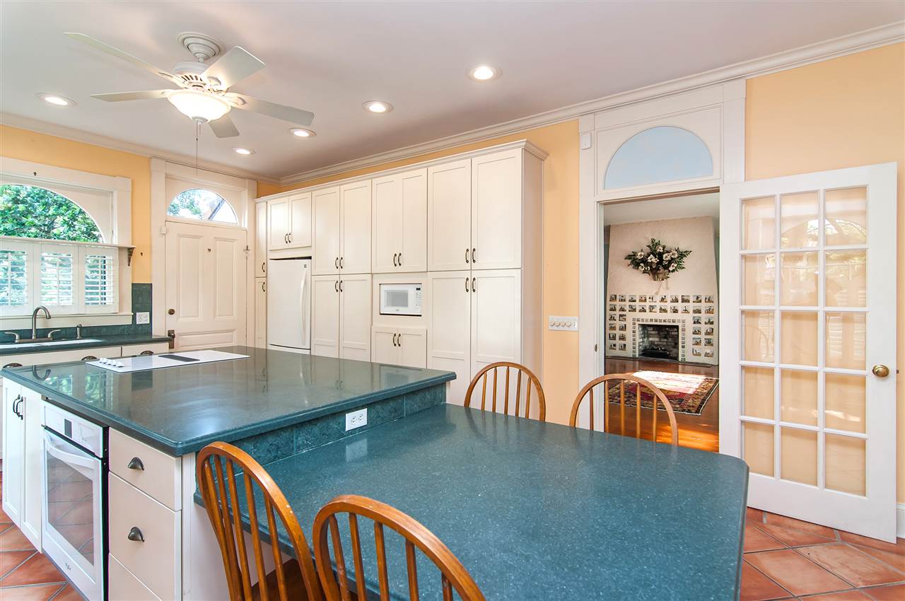 39 Valencia Street St. Augustine, FL 32084 - Photo 17 of 50 a kitchen with stainless steel appliances granite countertop a stove a sink a dining table and chairs with wooden floor