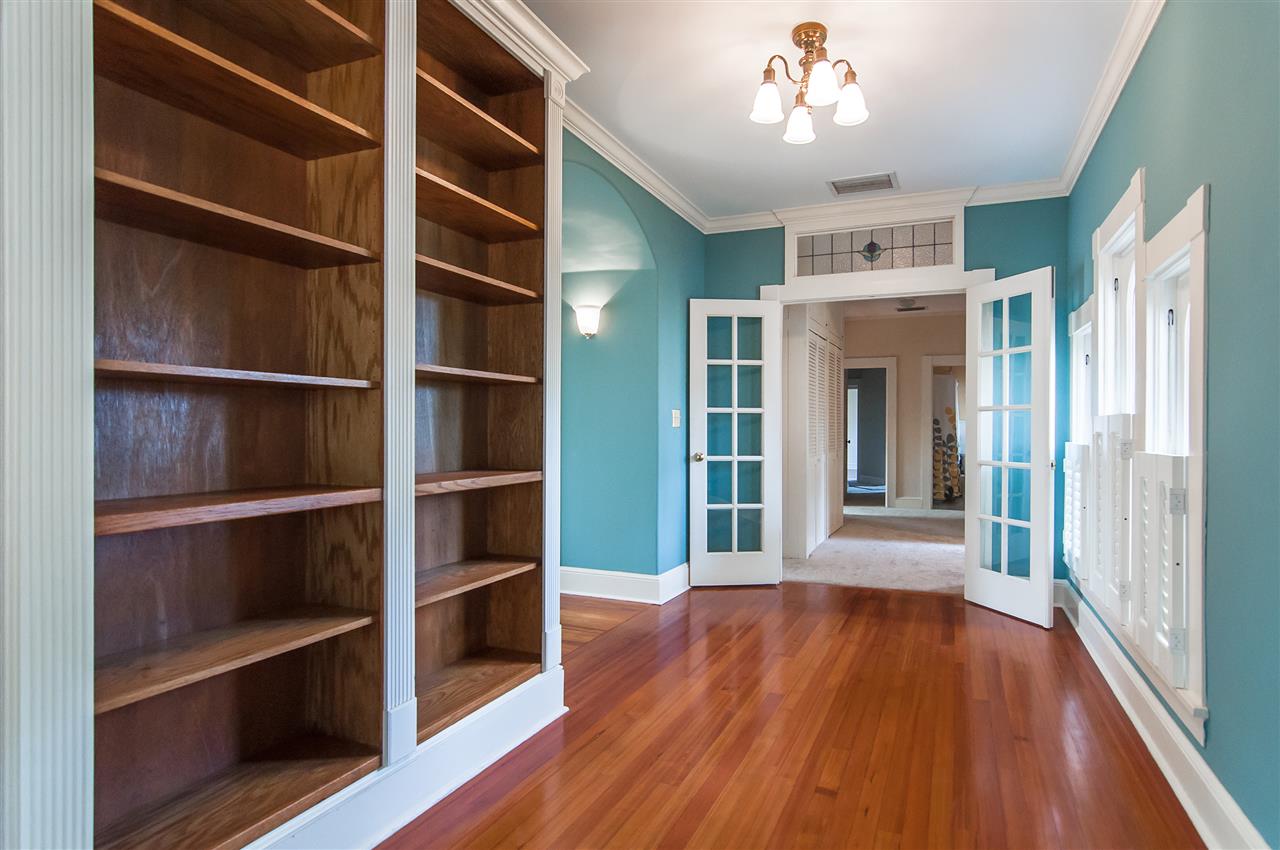 39 Valencia Street St. Augustine, FL 32084 - Photo 42 of 50 a view of an empty room with wooden floor and a window