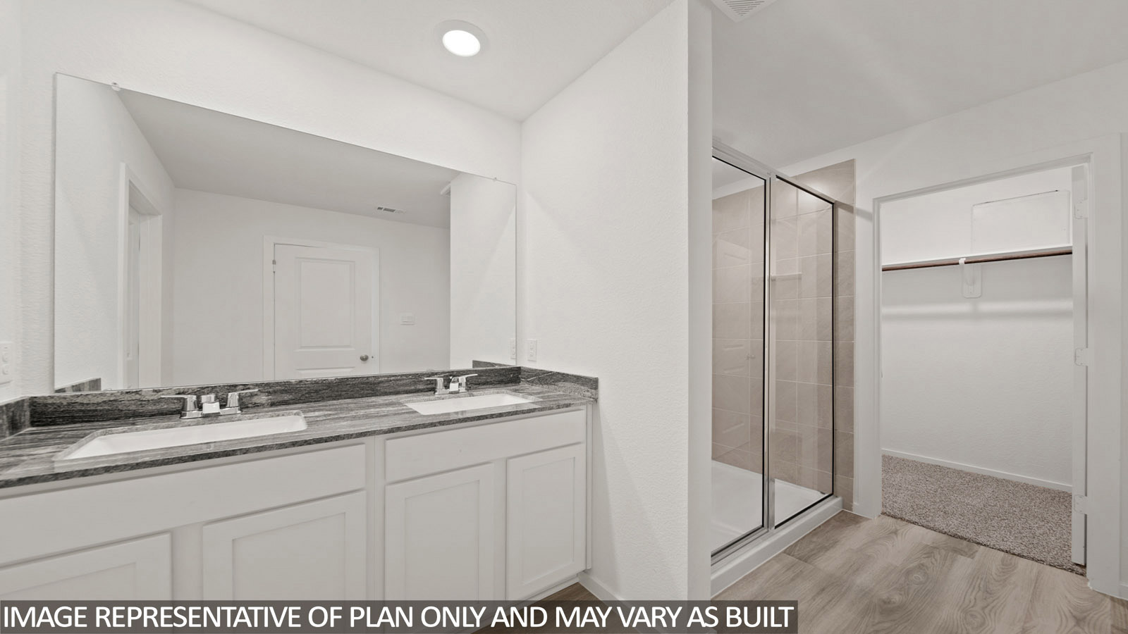 228 Flying Tigers Trail Jarrell, TX 76537 - Photo 11 of 17 Bathroom featuring a dual vanity with undermount sinks, stone-finish countertop, and a large wall-mounted mirror