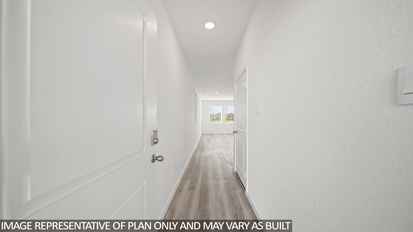 228 Flying Tigers Trail Jarrell, TX 76537 - Photo 2 of 17 Interior hallway featuring light wood-finish flooring, white walls, recessed ceiling lighting, and a white interior door with a silver handle